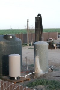 Javan's "new" water pump in foreground next to her dry well hole. Behind is the old pump, also dry. Photo by Javan Briggs